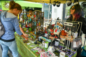 People shop for various wares at vendors at the Philly AIDS Thrift block party in South Philadelphia.