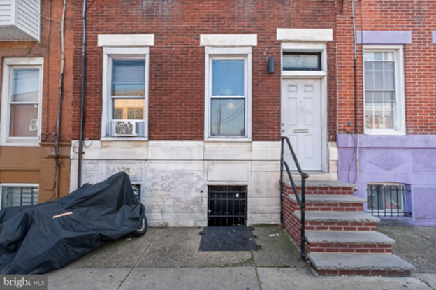 A brick and stone house located in South Philadelphia. There are steps leading up to the property. This property has 3 two-bedroom apartments.